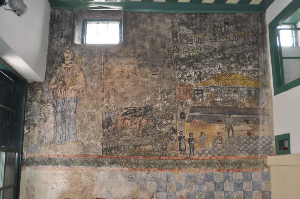 Τοιχογραφία Θεοφίλου όπου απεικονίζεται η ιστορία του ψωμιού, στον πρώην φούρνο «Μαρμαρέλλη - Χατζηκωνσταντή», Μεσαγρός Λέσβου.